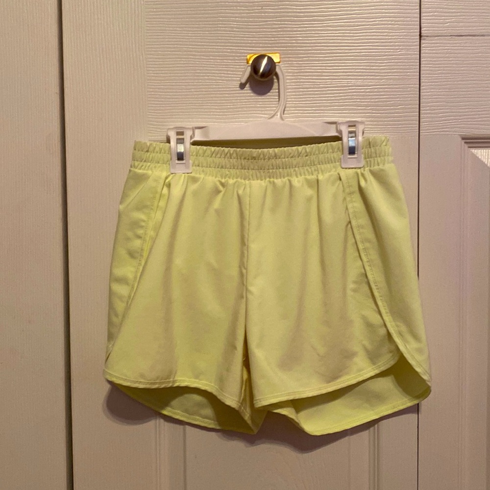these are neon green athletic shorts which are pretty high wasted and kinda long